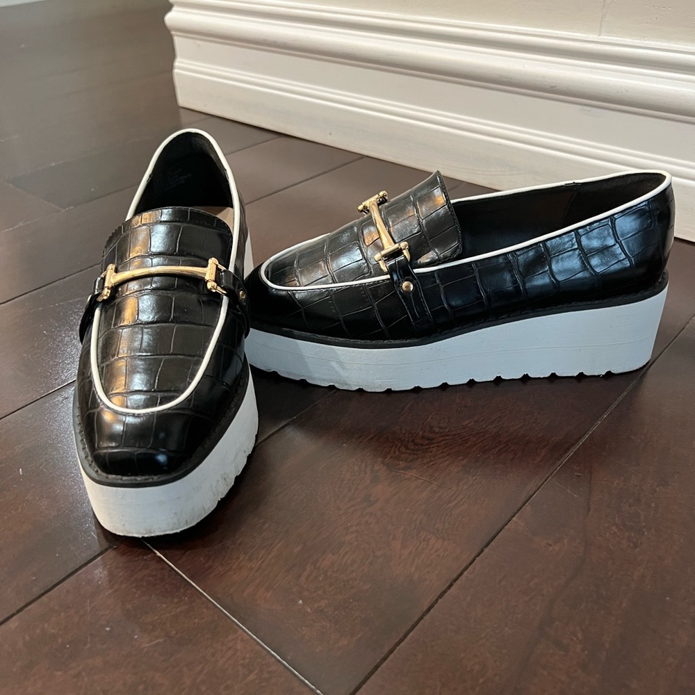 Black crocodile leather platform loafer with gold buckle.
